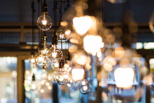 Hanging glass light bulbs glowing warmly in a dim setting.