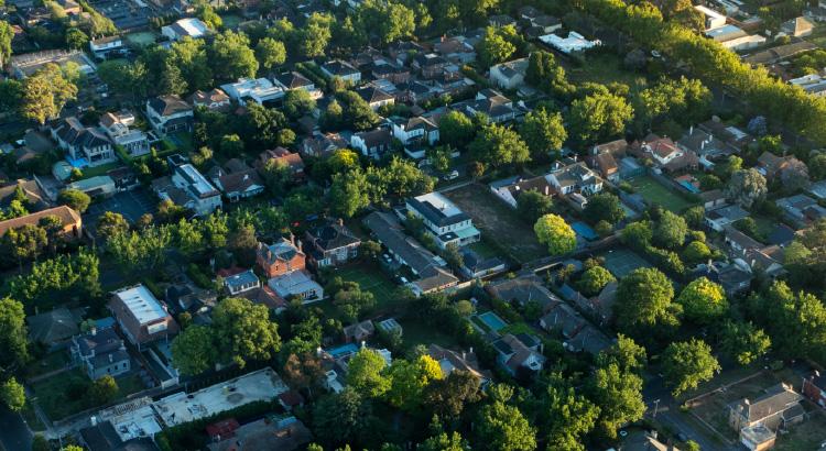 Aerial view of a leafy suburban neighborhood with houses and trees.