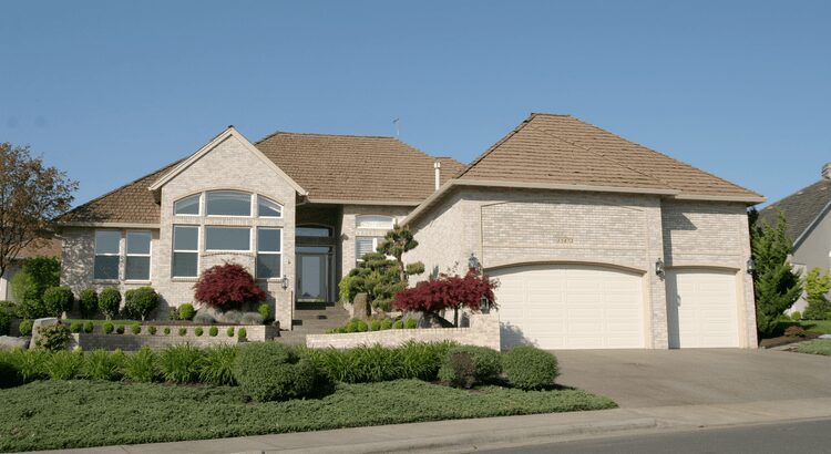 Beautiful suburban house with a neatly manicured lawn and garage.