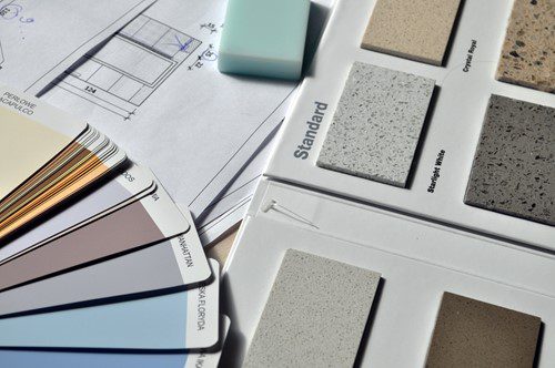 Interior design samples and color swatches on a blueprint.