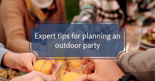 People toasting with drinks at an outdoor party.