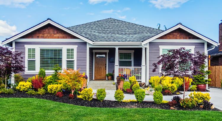 A charming single-story house with a manicured front yard.