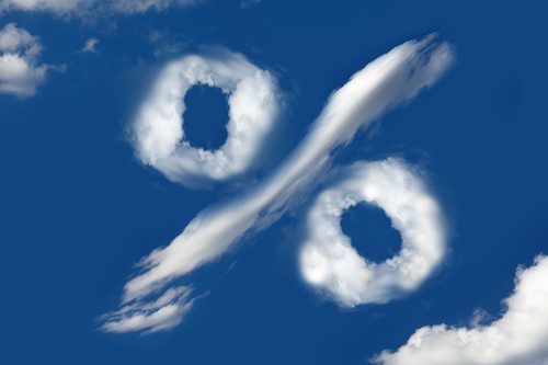 Percentage symbol made of clouds against a blue sky.