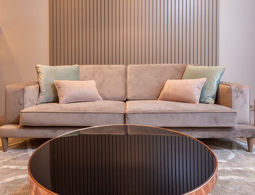 Modern beige sofa with cushions in a stylish living room.