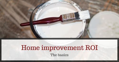 Paintbrush resting on an open can of white paint for home improvement.