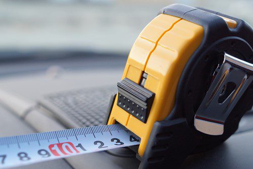 Close-up of a yellow tape measure extended on a surface.